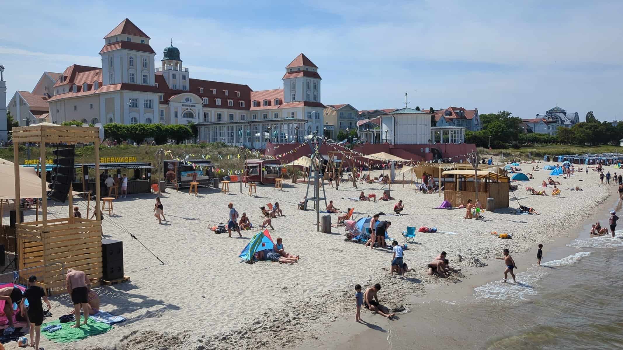 Binzer Strand mit Kurhaus im Hintergrund und Strandaktivitäten